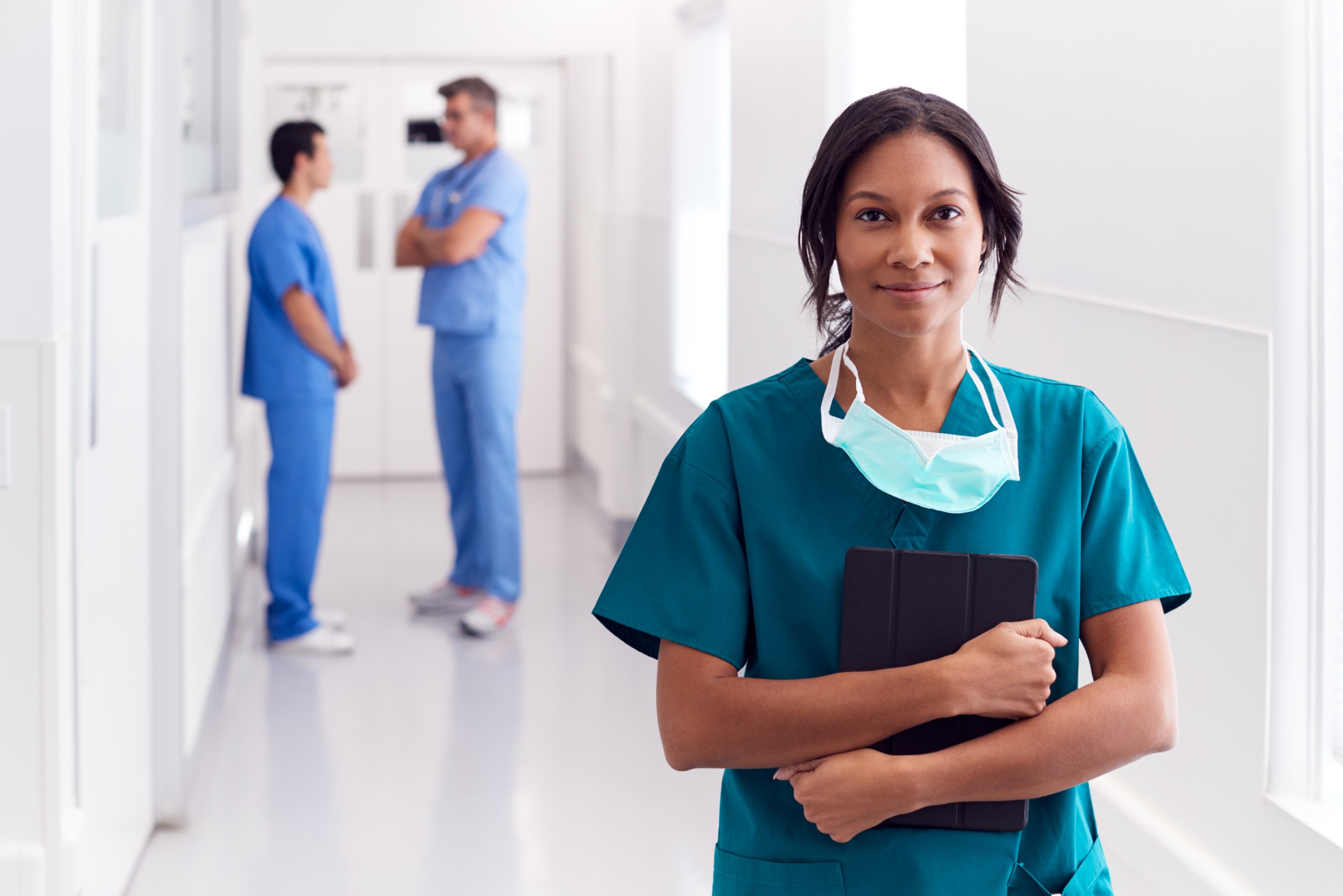 woman cosmetic surgeon standing in hospital hallway