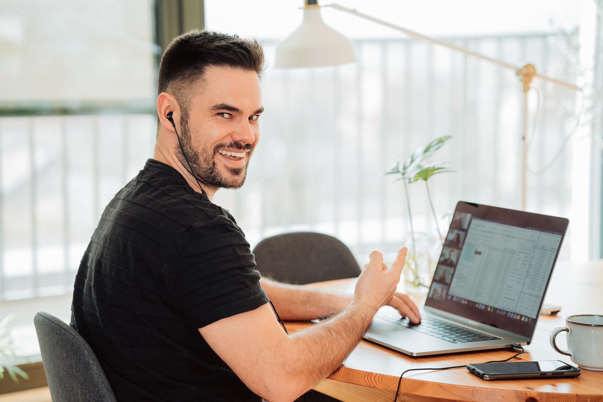 man on laptop smiling