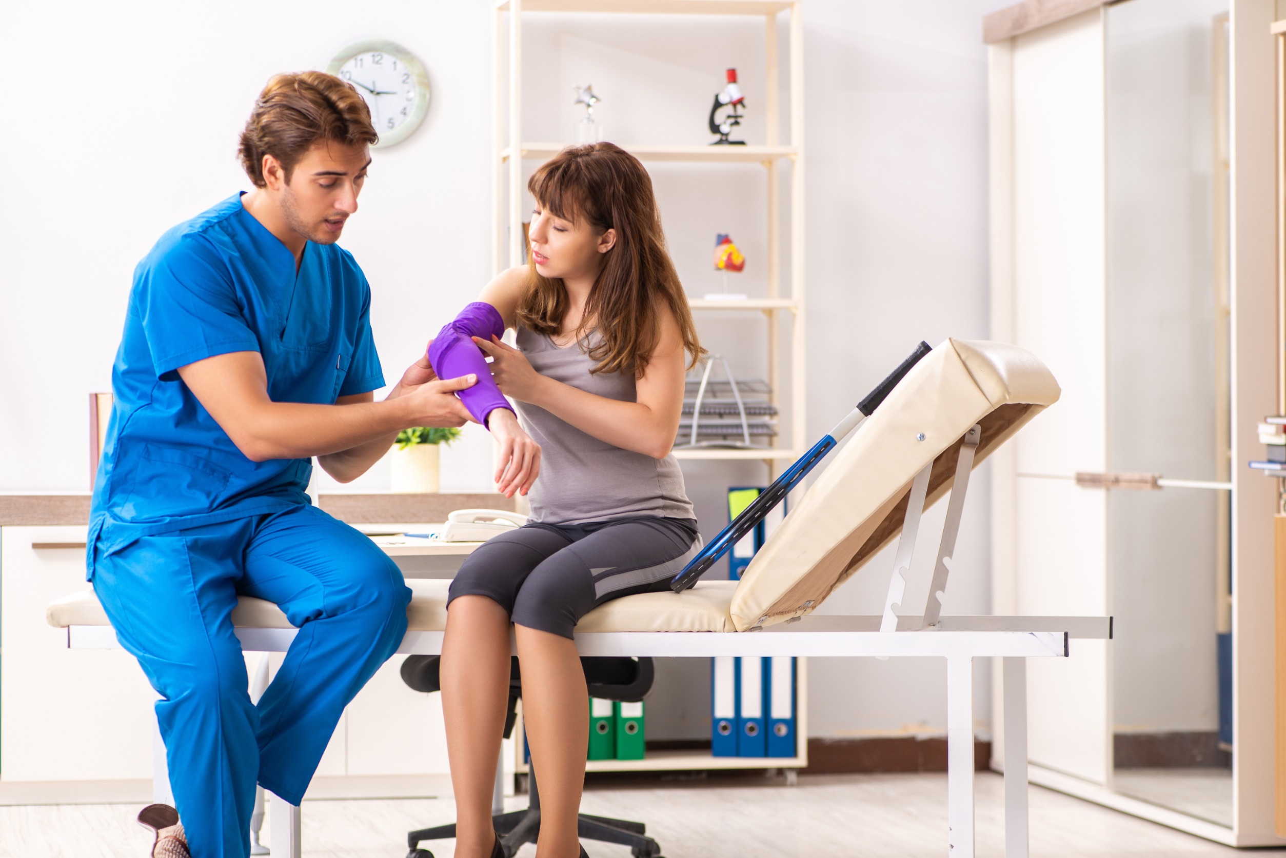 doctor looking at patient arm injury